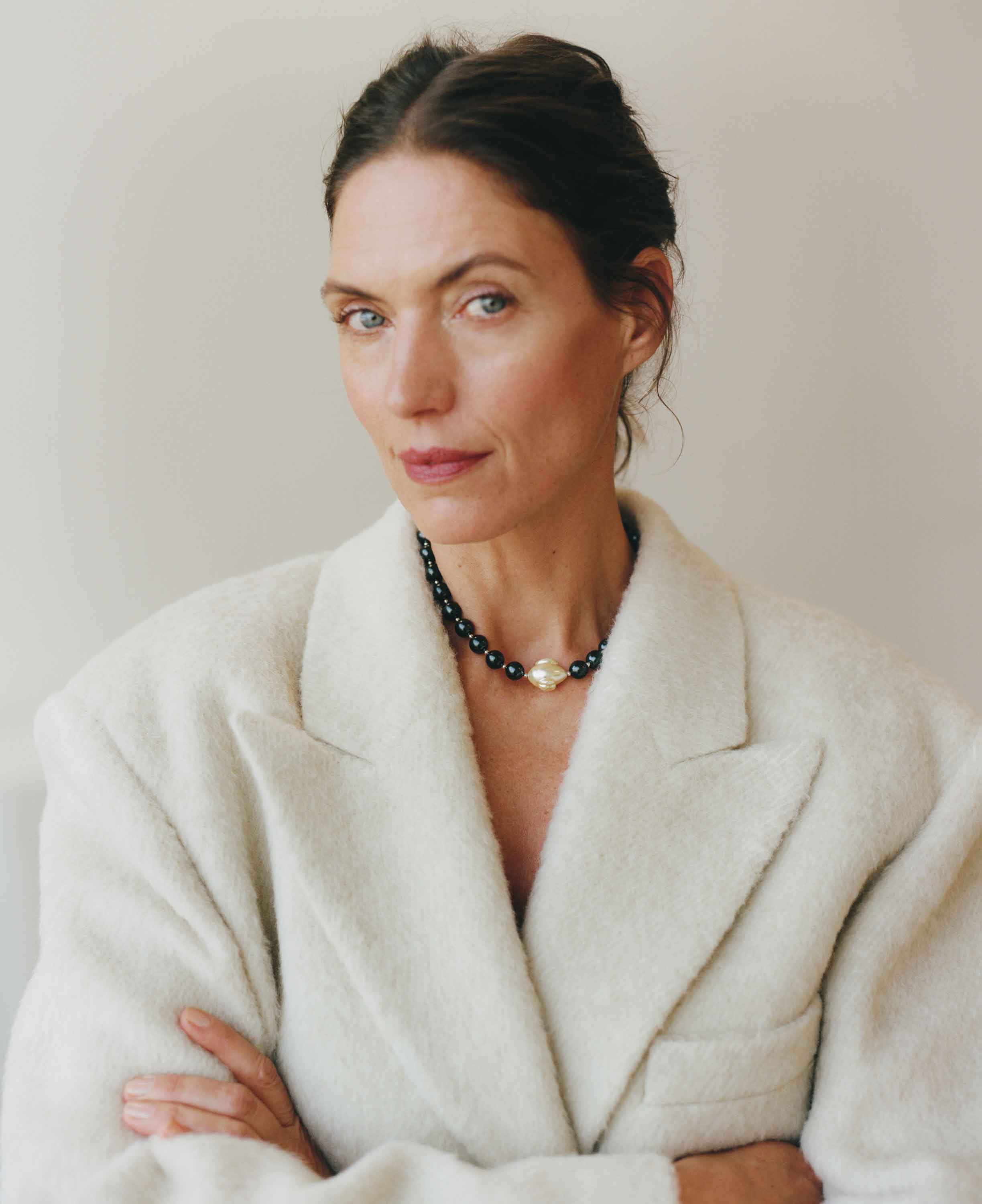 Woman wearing a white coat with a plain background