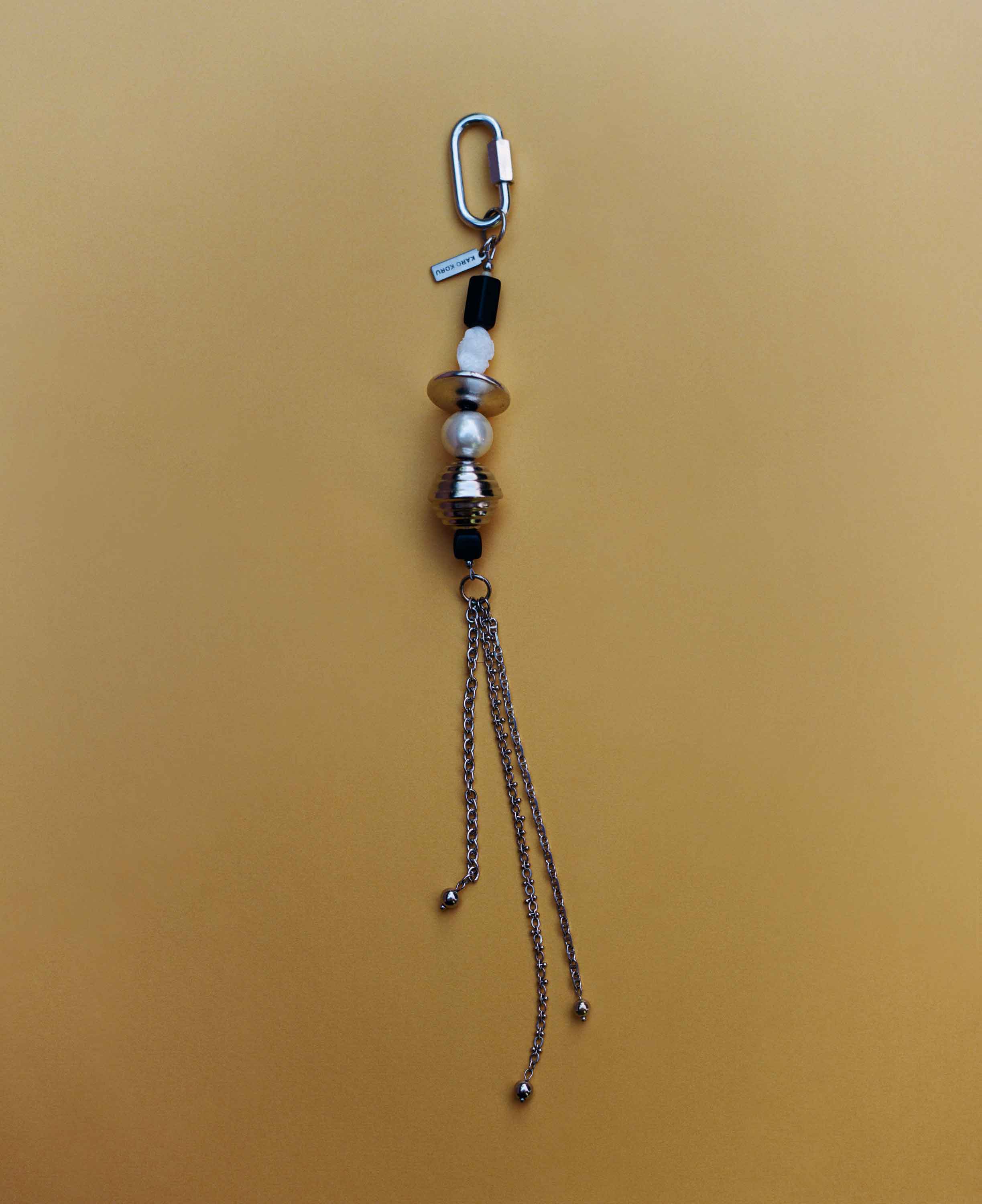 Keychain with beads and chain on a beige background