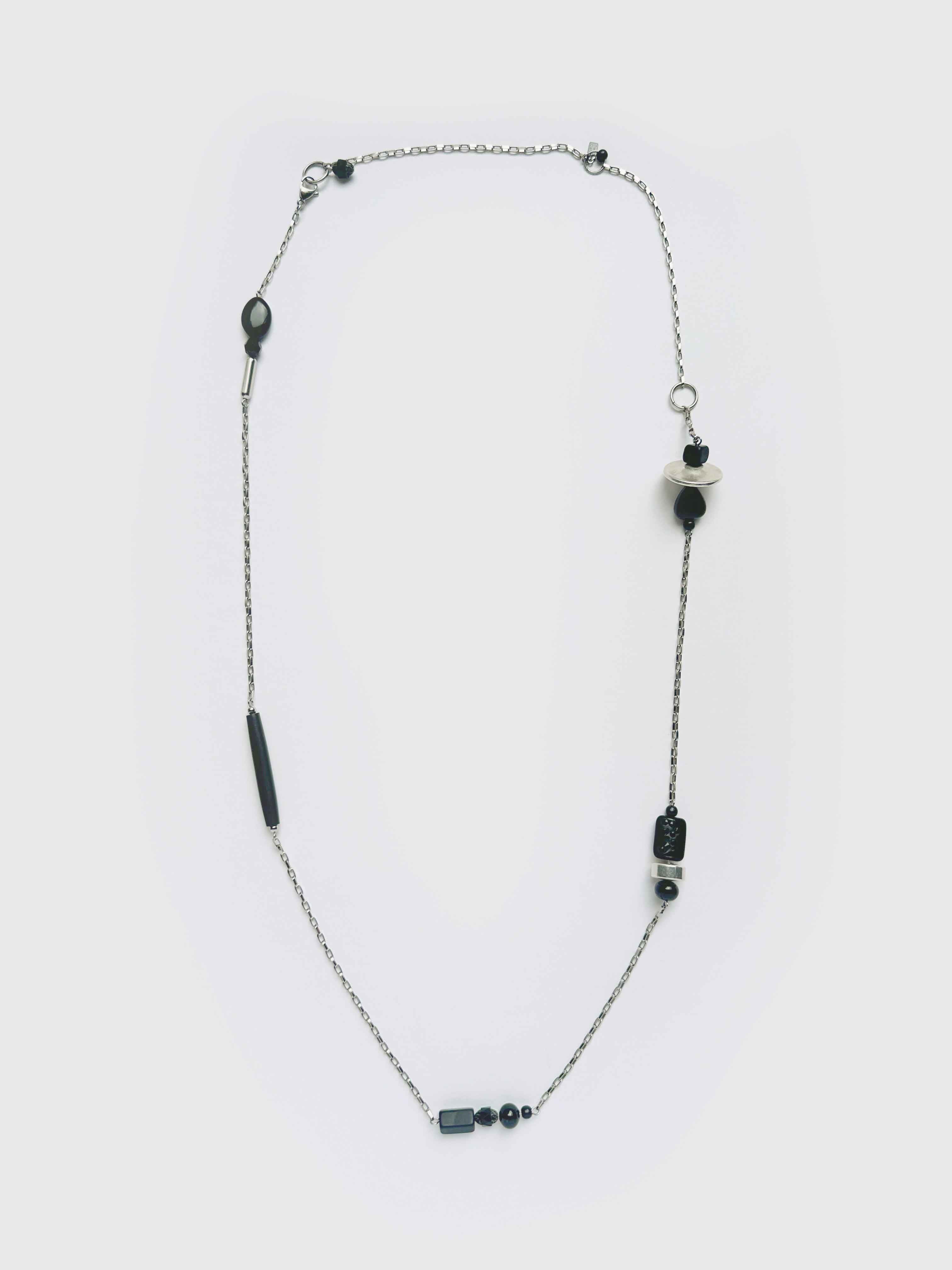 


Necklace with black beads on a white background