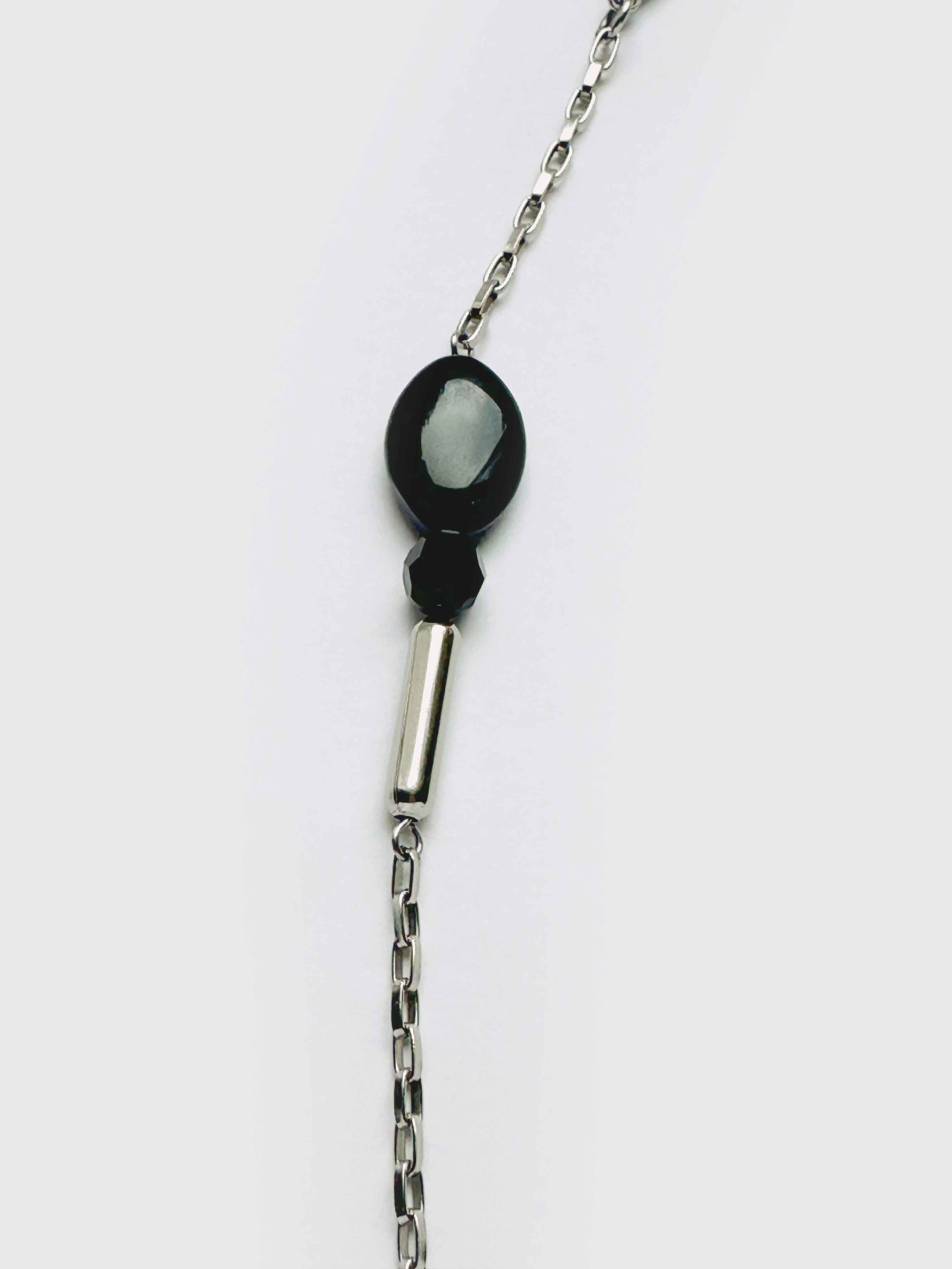 Necklace with a black pendant on a white background