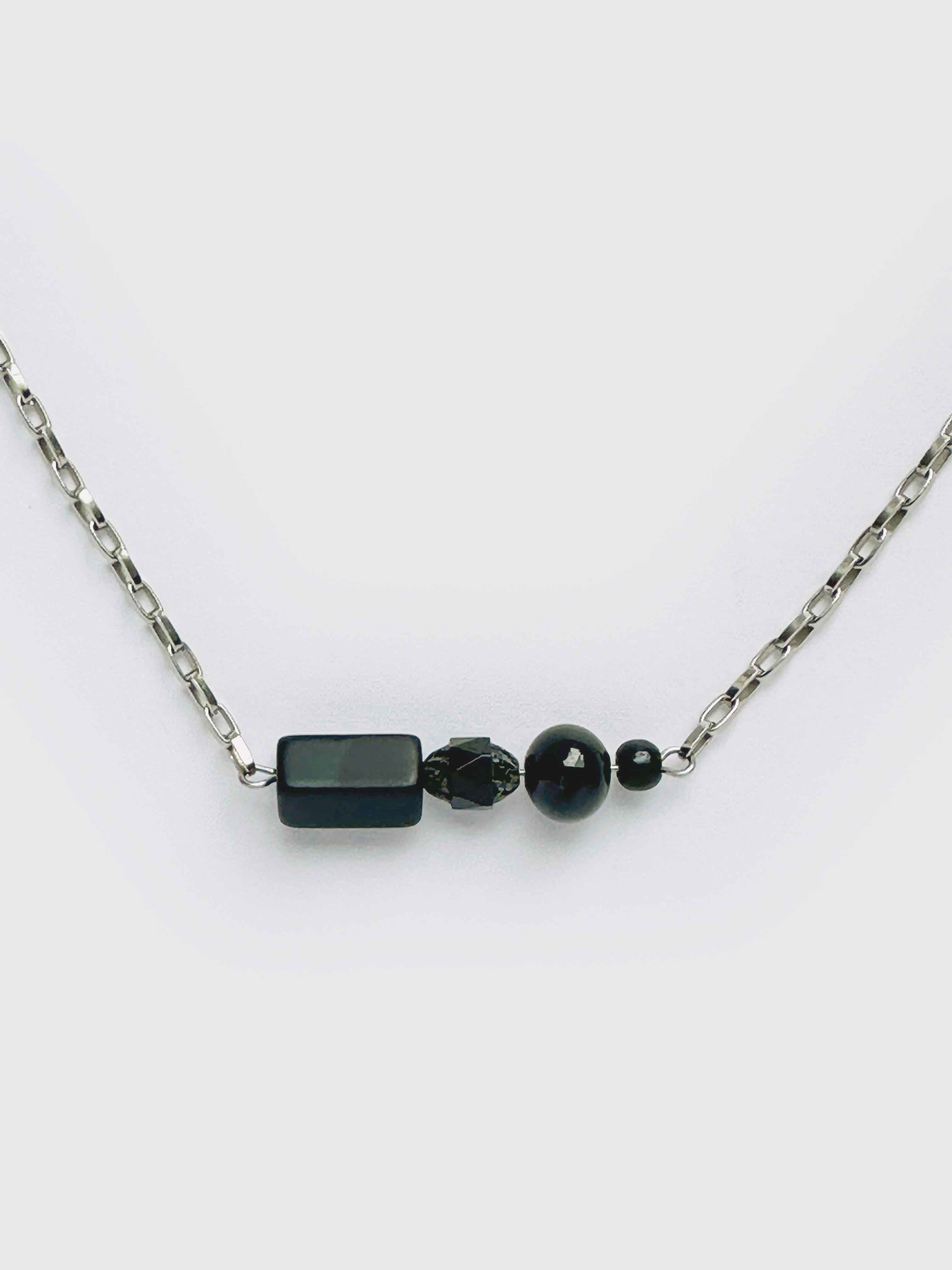 Necklace with black beads on a white background