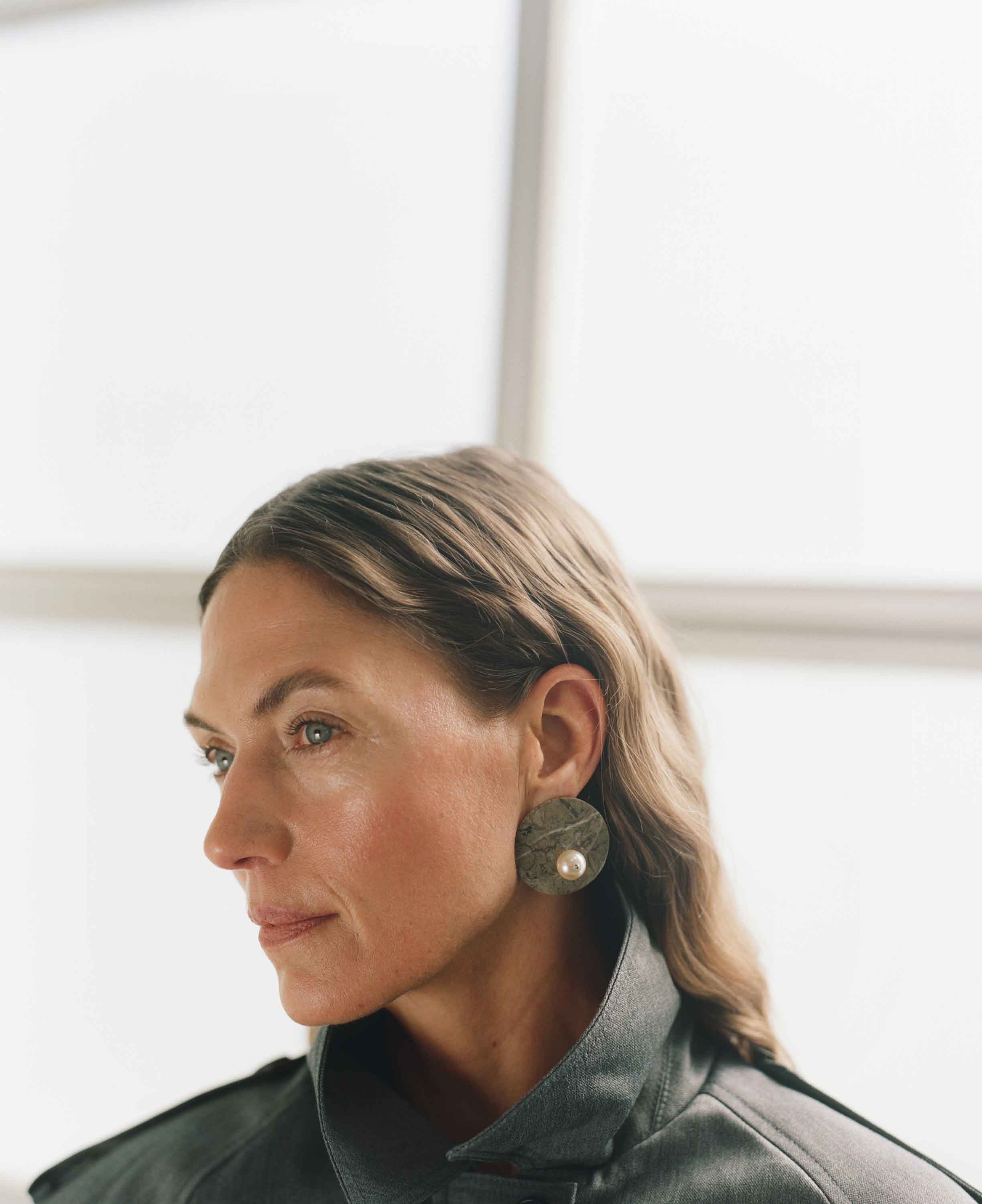 Woman wearing a green jacket with a blurred background